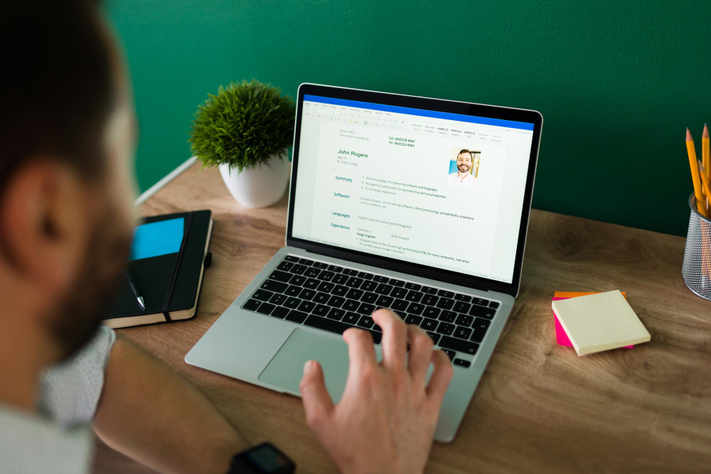 man-searching-new-job-working-writing-his-resume-laptop